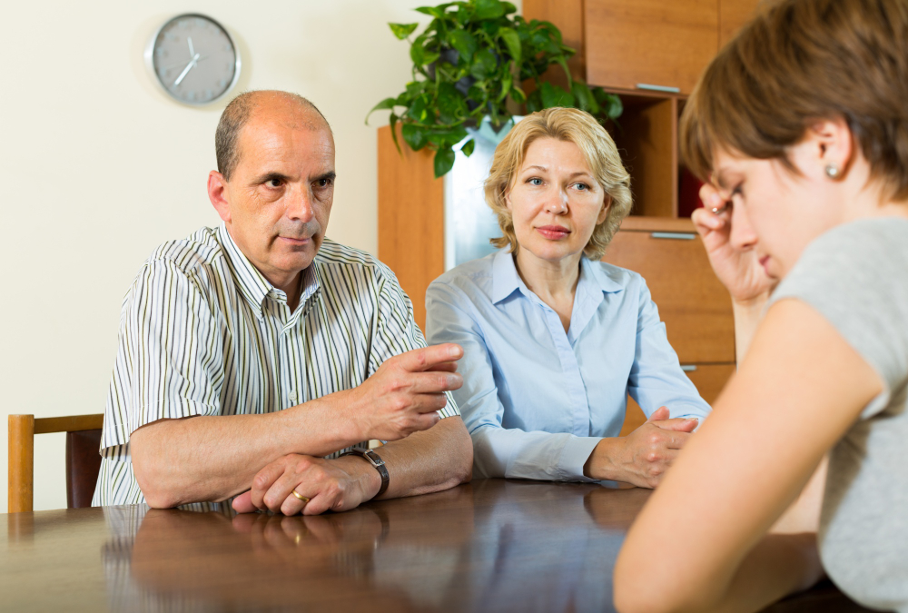 Parents having a tense discussion with daughter